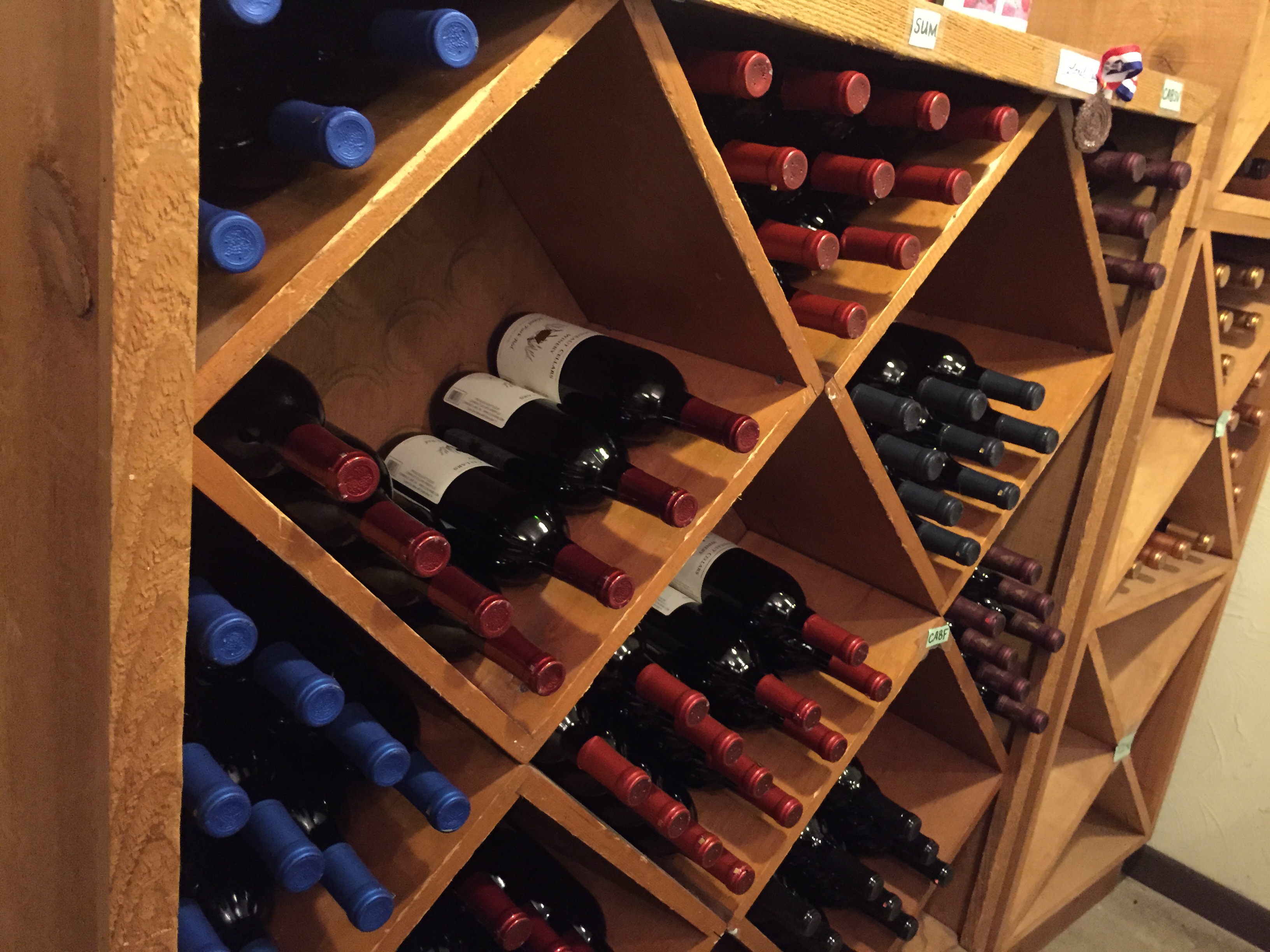 Various bottles of wine racked at Conneaut Cellars Winery & Distillery gift shop and tasting room.