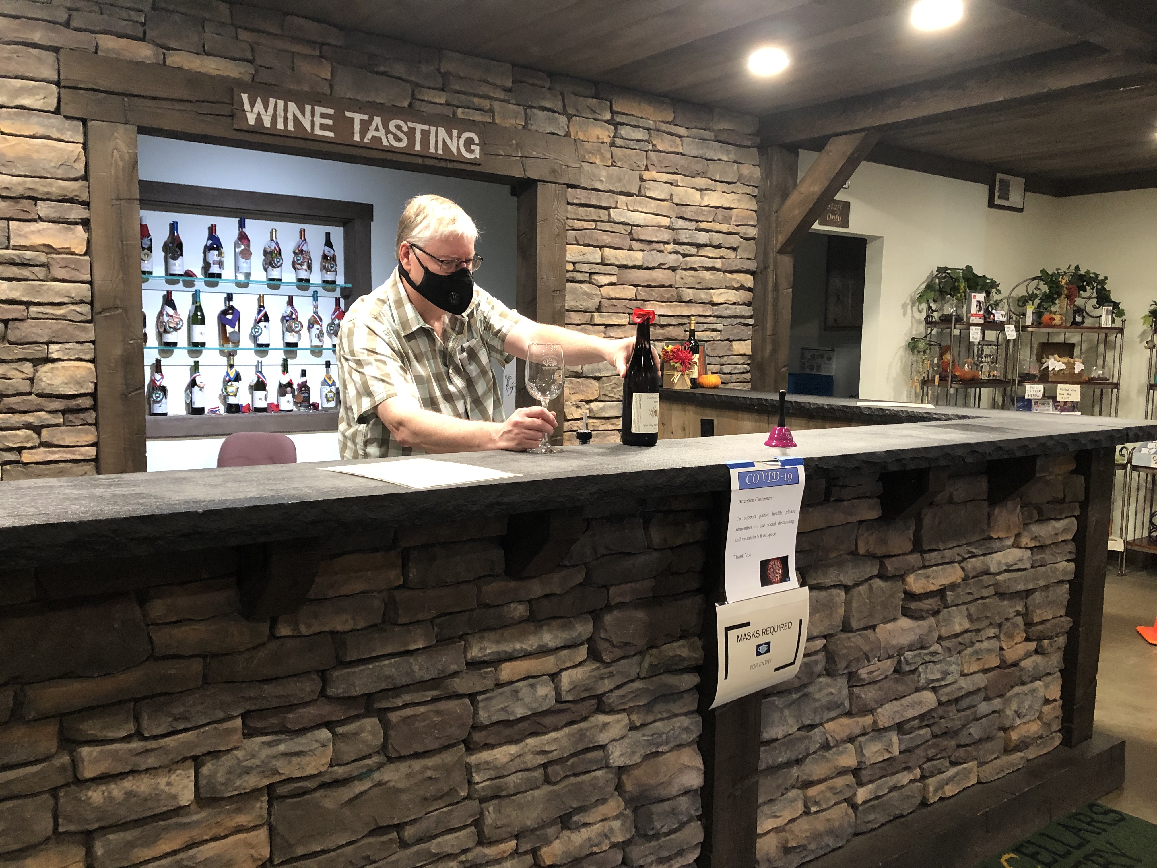 Joal Wolf, owner of Conneaut Cellars offering wine tasting at Conneaut Cellars Winery & Distillery.