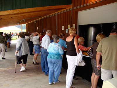 Customers enjoying wine and music at the Conneaut Cellars Winery & Distillery summer picnic event.